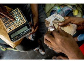 A trader counts a bundle of cash in the market, Lagos market, Lagos Island on the 22nd April, 2022