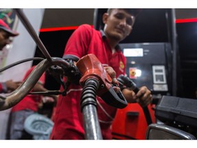 A worker fills up a motorcycle with fuel at a gas station in Karachi, Pakistan, on Thursday, June 30, 2022. Pakistani government has increased gasoline prices by 14.83 rupees/liter to 248.74 rupees/liter effective July 1, the Pakistan Finance Ministery said in a statement. The levy imposed as one of prior actions set by the International Monetary Fund to to revive its loan program, Pakistan Finance Minister Miftah Ismail says at news conference. IMF to extend its bailout program to four years and enhance its funding by $1b to $7b.