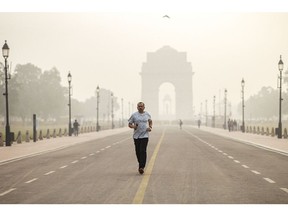 A runner shrouded in smog in New Delhi, India.