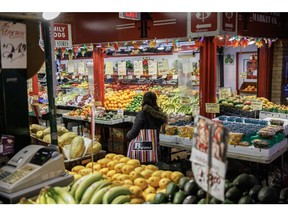 A shopper at a produce counter in St. Lawrence Market in Toronto in January.