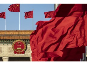 Chinese national flags fly over Tiananmen Square along with other red flags ahead of the fifth plenary session of the First Session of the 14th National People's Congress (NPC) at the Great Hall of the People in Beijing, China, on Sunday, March 12, 2023. China reappointed several top economic officials in a leadership reshuffle Sunday, giving investors greater continuity as Beijing overhauls financial regulation and grapples with escalating tensions with the US. Photographer: Qilai Shen/Bloomberg