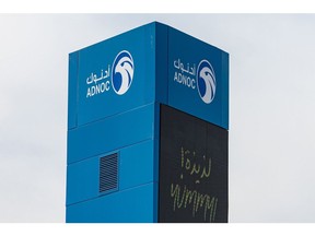 An Abu Dhabi National Oil Co. logo in Dubai. Photographer: Christopher Pike/Bloomberg