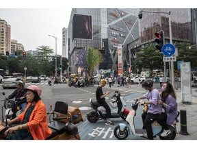 Motorists wait at a signal light in the Haizhu area of Guangzhou, China, on Tuesday, May 9, 2023. China's consumer inflation slowed to the weakest pace in two years in April while producer prices fell deeper into deflation, reflecting muted domestic demand and softer commodity costs.