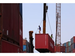 Workers on shipping containers at a depot in the Bang Na district of Bangkok, Thailand, on Friday, May 26, 2023. Thailand is scheduled to announce export figures on May 31.