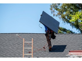 Workers install solar panels during a SunPower installation on a home in Napa, California, US, on Monday, July 17, 2023. SunPower Corp. is scheduled to release earnings figures on August 1.