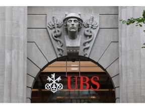 A logo above the entrance to the UBS Group AG headquarters in Zurich, Switzerland, on Thursday, Aug. 31, 2023. UBS posted the biggest-ever quarterly profit for a bank in the second quarter as a result of its emergency takeover of Credit Suisse, and confirmed that it would fully integrate the local business of its former rival by next year. Photographer: Arnd Wiegmann/Bloomberg