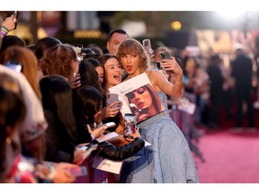 Taylor Swift greets fans at the world premiere of her concert movie.