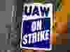 A "UAW On Strike" sign.