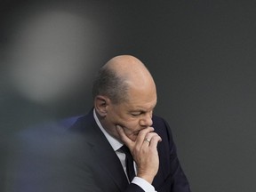 FILE - German Chancellor Olaf Scholz attends a debate fter his speech at the parliament Bundestag in Berlin, Germany, on Oct. 19, 2023. Chancellor Olaf Scholz says Germany needs to start deporting "on a large scale" migrants who don't have the right to stay in the country, adding to increasingly tough talk on migration since his coalition performed badly in two state elections earlier this month. Scholz's comments were published Friday, Oct. 20, 2021, as a leading German opposition figure called for the center-left chancellor to dump his quarrelsome coalition partners and instead form a government with conservatives to deal with migration issues.