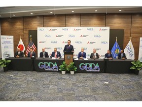 Grand River Dam Authority, Mitsubishi Power, and Oklahoma Secretary of State Josh Cockroft at the signing ceremony held at the Grand River Energy Center in Chouteau, OK. Pictured from left to right: Robert Ladd, VP of Generation, GRDA; Erik Feighner, Chief Financial Officer, GRDA; Dwayne Elam, GRDA Board Member; Dan Sullivan, President and CEO GRDA; John Wiscaver, EVP Strategic Communications, GRDA; Josh Cockroft, Oklahoma Secretary of State; Bill Newsom, President and CEO Mitsubishi Power Americas; Mark Bissonnette, EVP and COO, Power Generation, Mitsubishi Power Americas; Prasanth Thupili, SVP, Power Generation Services, Mitsubishi Power Americas (Credit: Grand River Dam Authority)