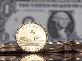 The Canadian dollar is falling after the Bank of Canada announced another rate pause and forecast weaker economic growth.