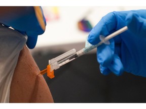 A healthcare worker administers the Covid-19 vaccine.