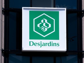 A Desjardins sign in Montreal. The company is cutting 400 jobs, it said Oct. 19.