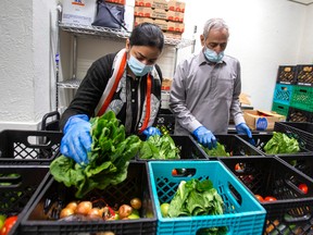 Volunteers at a food bank in Toronto. Visits to food banks have surged 32 per cent from last year.
