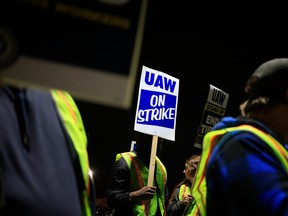 Factory workers and UAW union members form a picket line outside the Ford Motor Co. Kentucky Truck Plant in the early morning hours on Oct. 12.