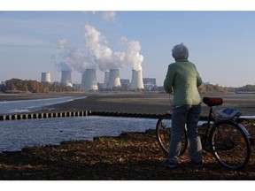 A woman looks toward a lignite coal-fired power plant in Peitz, Germany.