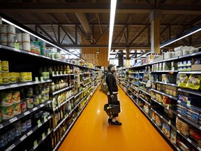 A shopper browses products at a Loblaw Cos. grocery store in Toronto. Loblaw said it has worries food prices will go up under a grocery code of conduct.