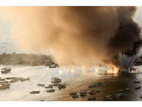 Smoke billows after a strike on the port of Gaza City on Oct. 10. Photographer: Mahmud Hams/AFP/Getty Images