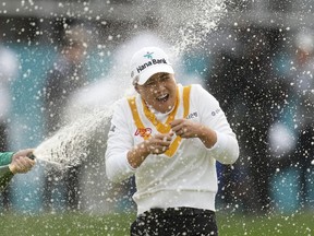 Minjee Lee of Australia is sprayed with champagne by Hannah Green of Australia after winning the BMW Ladies Championship at the Seowon Hills Country Club in Paju, South Korea, Sunday, Oct. 22, 2023.