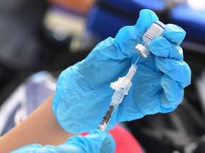 The Pfizer Inc. COVID-19 vaccine is prepared for administration at a vaccination clinic for homeless people in Los Angeles, California.