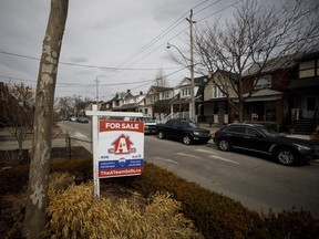 A 'For Sale' sign in front of a home in the York neighbourhood of Toronto.