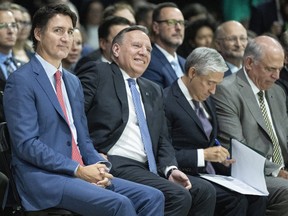 Prime Minister Justin Trudeau, from left to right, Quebec Premier Francois Legault, Minister of Innovation, Science and Industry Francois-Philippe Champagne and Quebec Economy and Innovation Minister Pierre Fitzgibbon attend an announcement that Northvolt Batteries North America will build a new electric vehicle battery manufacturing plant near Montreal, Sept. 28, 2023.