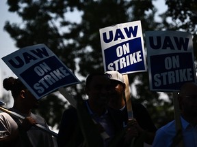 Members of the United Auto Workers and their supporters walking the picket line in front of the Chrysler Corporate Parts Division in Ontario, California, on Sept. 26, 2023.