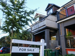 A 'For Sale' is sign is displayed in front of a house in the Riverdale area of Toronto.