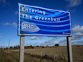 An Ontario Greenbelt sign surrounded by farmland near Caledon, Ont.