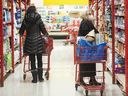 People shop in a grocery store in Montreal.