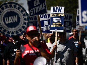 Labour supporters and members of the United Auto Workers union Local 230 march along a picket line during a strike outside of the Stellantis NV Chrysler Los Angeles Parts Distribution Center in Ontario, California.
