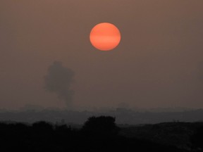 Smoke rises following an Israeli airstrike in the Gaza Strip, as seen from southern Israel, on Oct. 23, 2023.