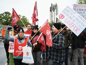 St. Lawrence Seaway workers strike outside the St. Lambert Lock in Saint-Lambert, Que.