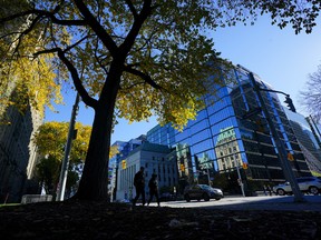 People make their way past the The Bank of Canada in Ottawa.