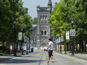 A person walks past the University of Toronto campus in Toronto.