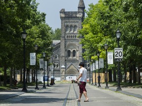 A person walks past the University of Toronto campus in Toronto.