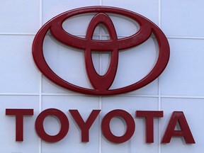 FILE - The Toyota logo is shown on a dealership in Manchester, N.H., in this Thursday, Aug. 15, 2019, file photo. Toyota will invest an additional $8 billion in the hybrid and electric vehicle battery factory it's constructing in central North Carolina, more than doubling its prior investments and expected number of new jobs, the company announced Tuesday, Oct. 31, 2023.