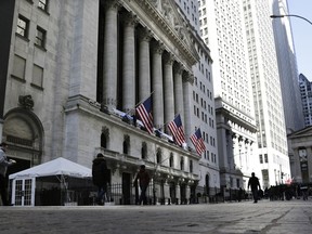 People pass the front of the New York Stock Exchange in New York, Tuesday, March 21, 2023. Stocks are rising on Wall Street, including the banks most beaten down by the industry's crisis.