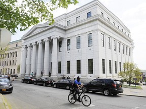 FILE - A cyclist rides past the New York Court of Appeals on May 5, 2015, in Albany, N.Y. New York's highest court on Tuesday, Oct. 24, 2023, ruled police can resume a DNA searching method that can identify relatives of potential suspects, a technique that has helped solve crimes but caused privacy concerns.