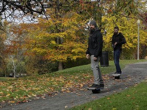 File - Two people ride Onewheels through Wright Park in Tacoma, Wash., on Oct. 26, 2018. All models of Onewheel self-balancing electric skateboards are under recall after at least four deaths and multiple injuries were reported in recent years, federal regulators said last week.