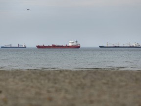 Ships sit idle in Lake Ontario close to the Welland Canal, Thursday, Oct. 26, 2023. The St. Lawrence Seaway Management Corp. says ships are expected to start moving this morning after it reached a tentative deal with Unifor to end a strike by workers.THE CANADIAN PRESS/Tara Walton