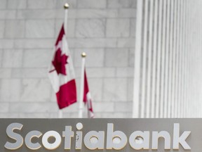 Scotiabank signage is pictured in the financial district in Toronto, Friday, Sept. 8, 2023. Scotiabank says it's cutting about three per cent of its global workforce as a result of changes at the bank and customers' day-to-day banking preferences, as well as ongoing efforts to streamline operations.THE CANADIAN PRESS/Andrew Lahodynskyj