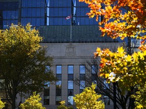 The Bank of Canada building is framed by fall-coloured leafs in Ottawa on Monday, Oct. 23, 2023.