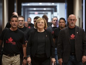 Unifor national president Lana Payne leads the way towards a meeting with Stellantis as part of the auto talks in Toronto on Thursday, Aug.10, 2023.&ampnbsp;Unifor says Canadian autoworkers have gone on strike at Stellantis operations in Canada after failing to reach a deal by Sunday's deadline.