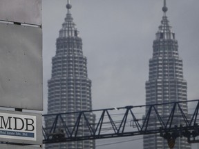 FILE - In this Wednesday, July 8, 2015 photo, a 1MDB (1 Malaysia Development Berhad) logo is set against the Petronas Twin Towers at the flagship development site, Tun Razak Exchange in Kuala Lumpur, Malaysia. The Malaysian government questioned Thursday, Oct. 12, 2023, a move by Goldman Sachs to file for arbitration in a dispute over a settlement of a case involving the multibillion-dollar looting of a sovereign wealth fund.