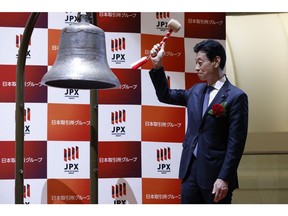 Yasutoshi Nishimura during a ceremony at the Tokyo Stock Exchange on Oct. 11. Photographer: Kiyoshi Ota/Bloomberg