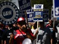 Labour supporters and members of the United Auto Workers union (UAW) Local 230 march along a picket line during a strike outside of the Stellantis Chrysler Los Angeles Parts Distribution Center in Ontario, Calif., on Sept. 26, 2023.