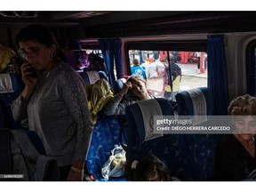 TOPSHOT - Armenian refugees from Nagorno-Karabakh are seen in the center of the town of Goris on September 30, 2023 before being evacuated in various Armenian cities. Armenia said on September 30, 2023 100,417 people from an estimated population of 120,000 had fled Nagorno-Karabakh since the breakaway region saw its decades-long fight against Azerbaijani rule end in sudden defeat. (Photo by Diego Herrera Carcedo / AFP)