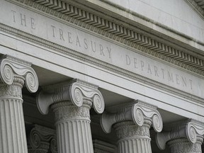 FILE - The Treasury Building is viewed in Washington, May 4, 2021. The U.S. Treasury Department said Thursday that it has imposed its first set of sanctions on two companies that shipped Russian oil in violation of a multinational price cap.