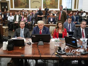 FILE - Former President Donald Trump, center, sits in the courtroom with his legal team before the continuation of his civil business fraud trial at New York Supreme Court, Oct. 3, 2023, in New York. Trump is returning Oct. 17 to the Manhattan civil fraud trial that threatens to upend his real estate empire.